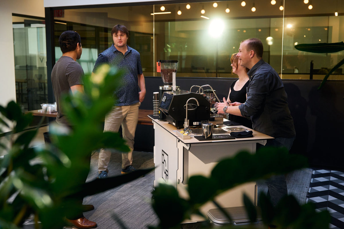 Guests around the Boxwood Coffee espresso cart at a corporate event